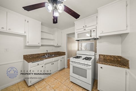 a kitchen with white appliances and granite counter tops